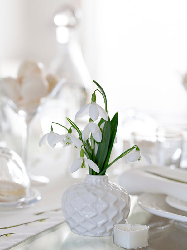 Snowdrops table setting. White flower vase and snowdrop table runner.