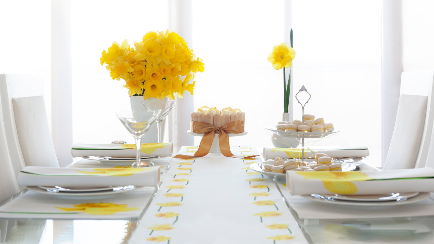 Spring Collection featuring yellow daffodils. Table runner, napkins and placemats. Also available as tea towel. This light white-yellow design will refresh and brighten any dining space.
